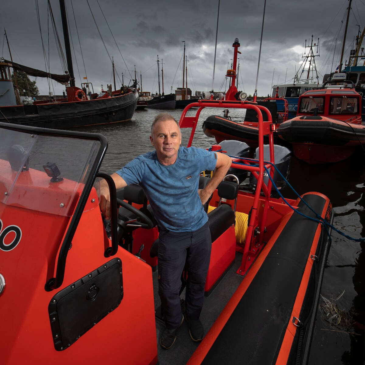Klaas Post aboard a red Post Workboats RIB in the harbour of Urk